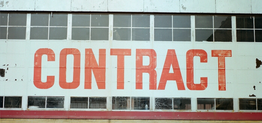a building with windows and a banner in front with the text 'CONTRACT' in big red letters